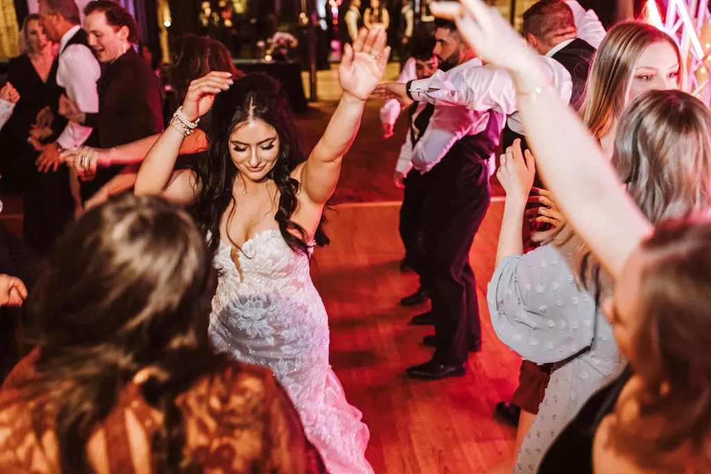 A bride dancing joyfully at her wedding reception
