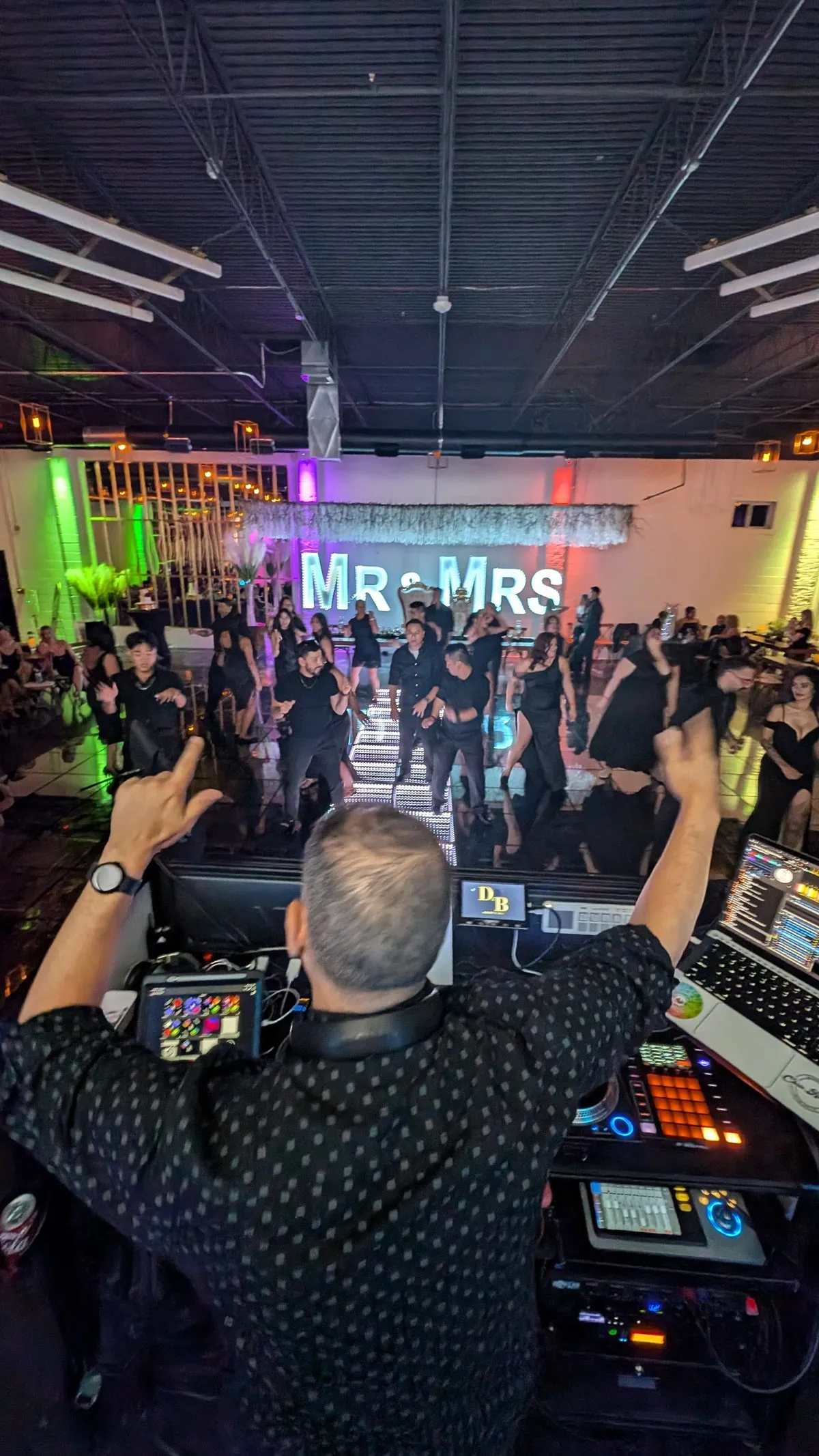 A Cutmaster Music DJ's-eye view of a packed dance floor at D'Venue, under a marquee MR & MRS sign