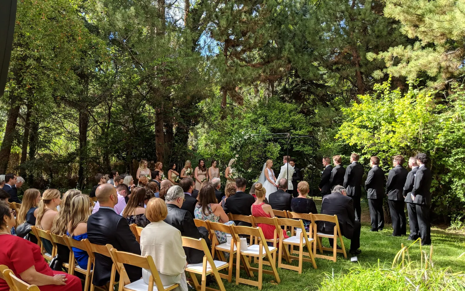 An outdoor wedding ceremony beneath the trees
