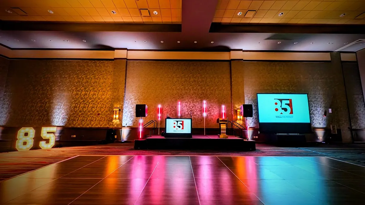 An 85th anniversary corporate event stage set up by Cutmaster Music in the Sandia Ballroom