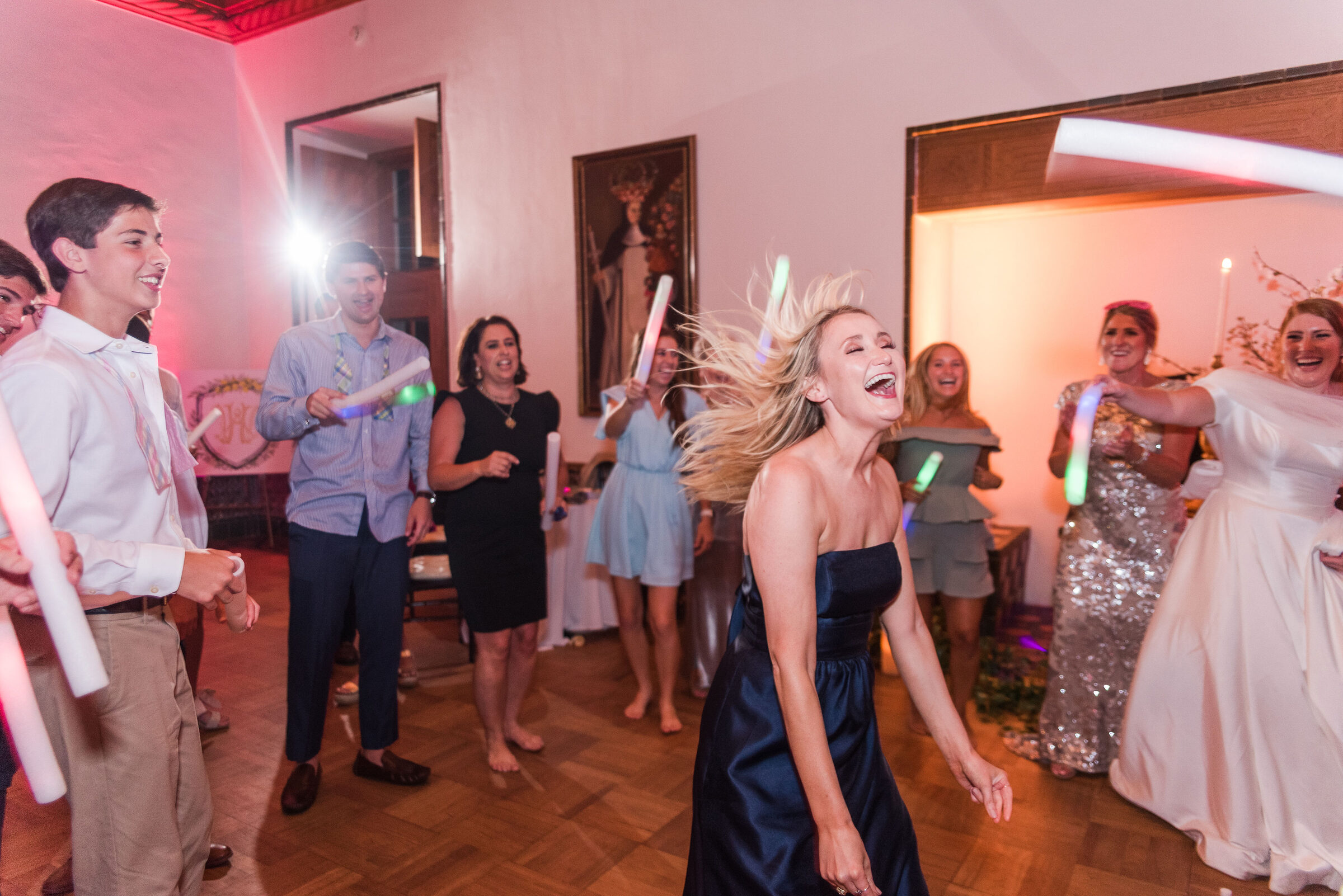 A packed dance floor with glow sticks