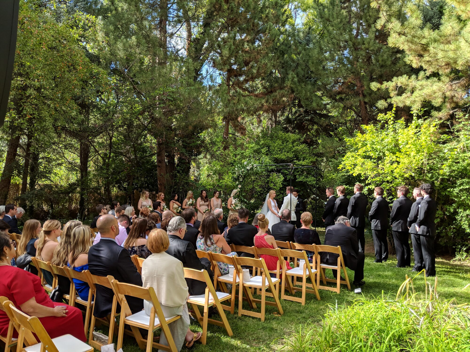 An outdoor wedding ceremony among the trees